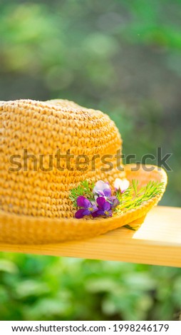 Summer photo. Straw hat with fresh flowers