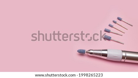 Nail tool. Cutters for hardware pedicure. Accessories and nail tool on yellow background. Milling cutter for manicure. Royalty-Free Stock Photo #1998265223