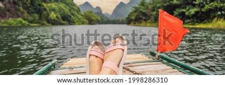 BANNER, LONG FORMAT Woman tourist in Trang An Scenic Landscape Complex in Ninh Binh Province, Vietnam A UNESCO World Heritage Site. Resumption of tourism in Vietnam after quarantine Coronovirus COVID