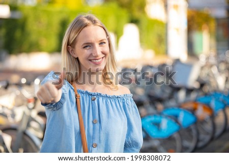 happy smiling beautiful young woman showing thumbs up