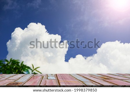 Stone balcony with cloudy background and light flare