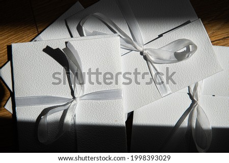 small gifts in white envelopes