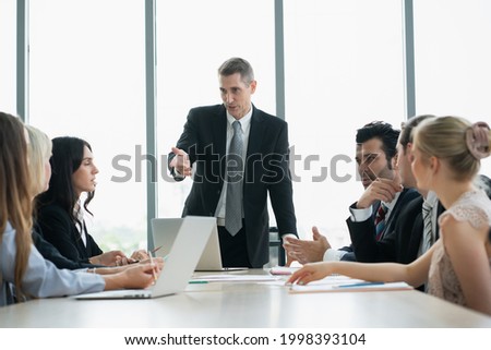 group of business people discussing together in meeting room