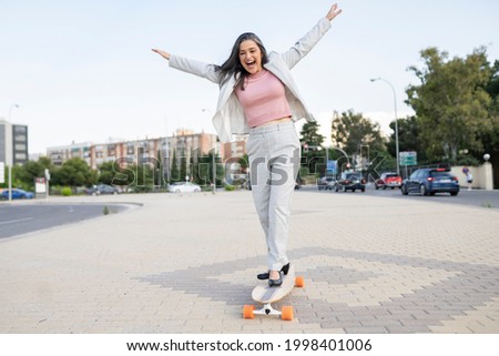 Beautiful senior woman riding with skateboard