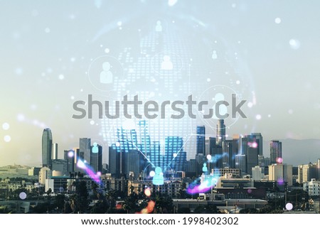 Virtual social network hologram and world map on Los Angeles skyline background. Multiexposure
