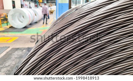 Close up side view of strand wires in storage area, coil strand wires in warehouse of factory Royalty-Free Stock Photo #1998418913