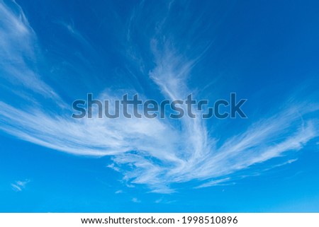 Clouds float in the sky in a streaky shape. on a clear day Royalty-Free Stock Photo #1998510896