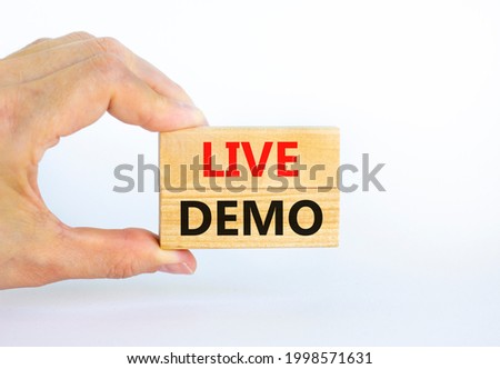 Live demo symbol. Concept words 'live demo' on wooden blocks on a beautiful white background. Businessman hand. Copy space. Business and live demo concept.
