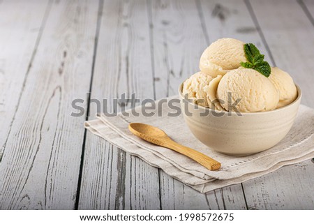 Bowl with vanilla ice cream balls. Royalty-Free Stock Photo #1998572675