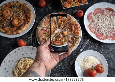 Guest taking a photo of food on mobile phone.