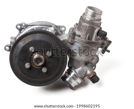 Metal automobile pump for cooling the engine of a water pump on a white background. The concept of used spare parts for the car engine from junkyard