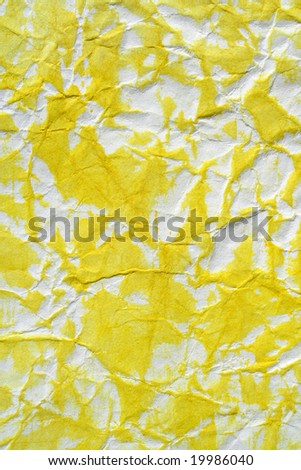 Yellow color semi painted wrinkled paper as background. Art is painted by photographer.