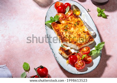 fried feta cheese with honey and tomato and basil salad Royalty-Free Stock Photo #1998613523