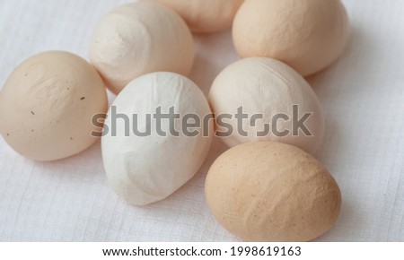 Deformed chicken egg on a wooden background. Ugly abnormal crooked egg. Royalty-Free Stock Photo #1998619163
