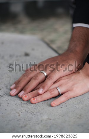 The hands of the bride and groom holding a beautiful wedding ring. wedding photo concept 
