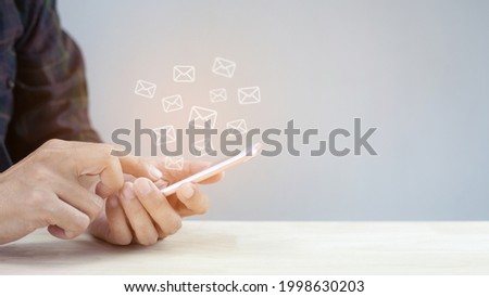 Email concept, hand man using mobile phone with email icon.