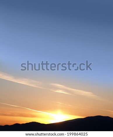 Sunset with mountains and blue sky