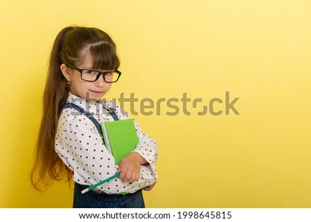 School concept. Back to School. Smart wunderkind in nerdy glasses and school uniform