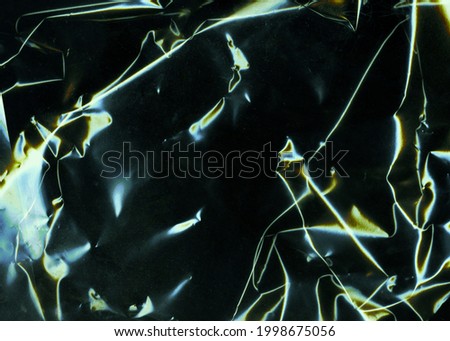Beautiful darkness plastic abstract background. No plastic bag concept, save world, protect earth. Freeze motion of dark powder exploding. Glossy polyethylene. plastic transparent. Space for text. 