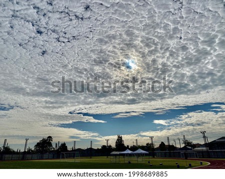 Altocumulus clouds above Football Field Royalty-Free Stock Photo #1998689885