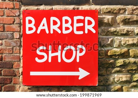 Barber shop red sign against old wall background