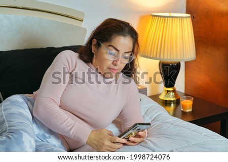 Girl with pretty glasses texting on her phone