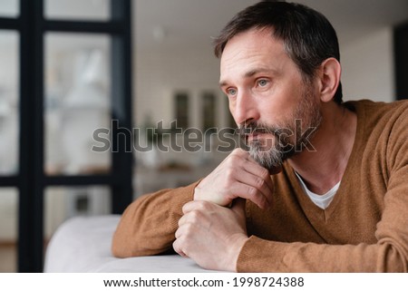 Sad mature middle-aged man depressed lonely having no visitors of his children. Divorce , bachelor , health problems concept. Lockdown, unemployment, needless man on social distance Royalty-Free Stock Photo #1998724388