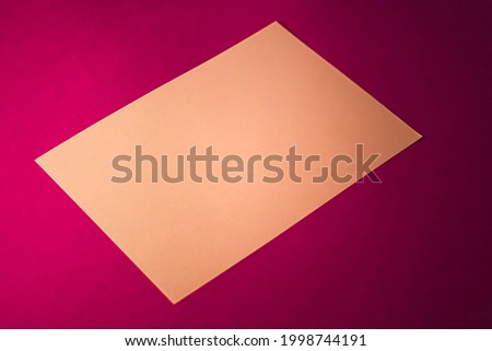 Blank A4 paper, brown on pink background as office stationery flatlay, luxury branding flat lay and brand identity design for mockup.