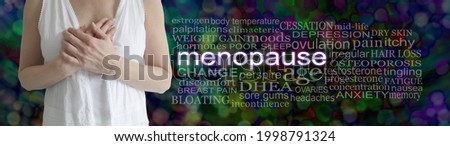 Words associated with the Female Menopause - mature female with hands across chest beside a MENOPAUSE word cloud on a dark multicoloured bokeh background
 Royalty-Free Stock Photo #1998791324