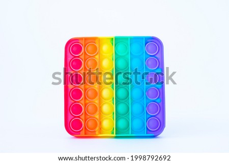 Colorful rainbow poppit game. Silicone fidget close-up on a white background Royalty-Free Stock Photo #1998792692