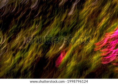 Soft, hazy, shades of green and grey with patches of bright, vibrant pink, light streak pattern - abstract, motion-blurred background texture