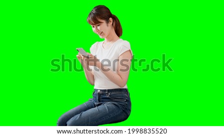 Chroma key synthesis for young women sitting and using smartphones