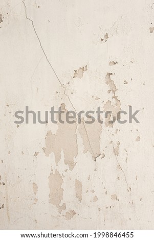 Beige Concrete cracks from the wall on texture background. Loft style of concrete house or building wall.