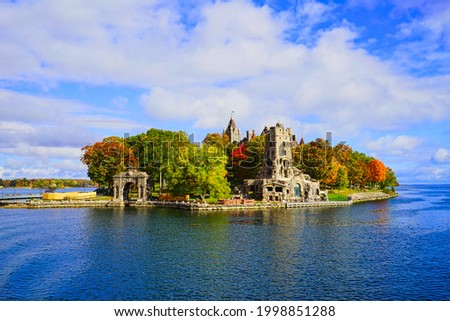 Historic Boldt Castle on Heart Island. Tree, leaves, river, blue sky.Autumn in the Thousand Islands at the St. Lawrence River. New York State, 2016.  Royalty-Free Stock Photo #1998851288