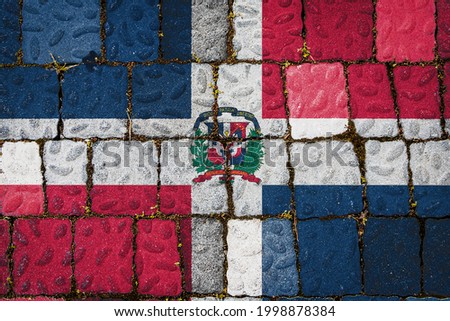 National flag of Dominicana on stone  wall background. Flag  banner on  stone texture background.