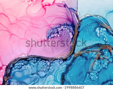 Alcohol ink fluid art. Waves in blue and pink colors with liquid golden inclusion. Abstract gradient background or texture