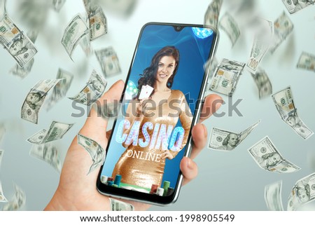 Beautiful girl with playing cards in her hand on the smartphone screen and falling dollars. Online casino, gambling, betting, roulette. Flyer, poster, template for advertising