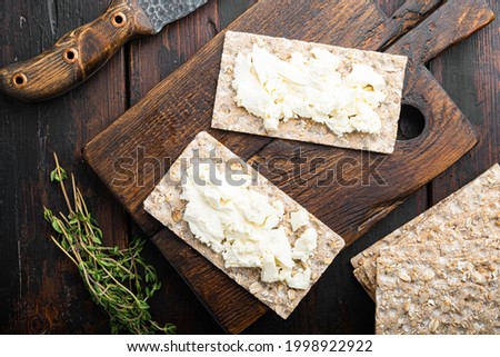 Crisp breads with butter set, on old dark  wooden table background, top view flat lay Royalty-Free Stock Photo #1998922922