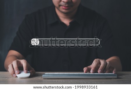 Man using computer laptop keyboard for online search engine information in network website browser. use as screen background search engine website concept.
