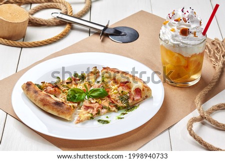 Pizza with bacon, leek, basil with lemonade topped with whipped cream