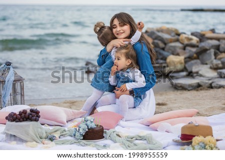 mother with children relaxing on the beach