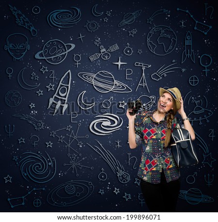 Excited woman with retro photo camera looking at draw space
