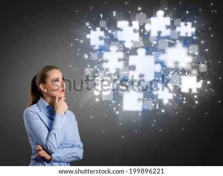 Thinking businesswoman looking at clouds of shining puzzle pieces Royalty-Free Stock Photo #199896221