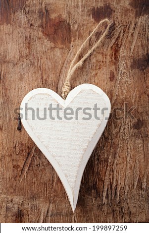 white wooden heart on old wooden background backdrop