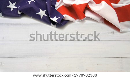 United states flag on white, weathered wooden clapboard background 