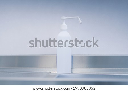 Disinfectant dispenser next to a sink inside an emergency room. Medical equipment.