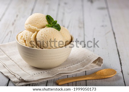 Bowl with vanilla ice cream balls. Royalty-Free Stock Photo #1999050173