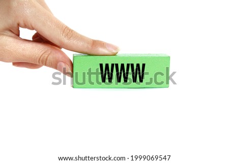 Woman's hand holding wooden block with the inscription  ''WWW''.  Isolated on white background.