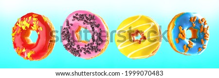 Fresh and tasty donuts on colorful background