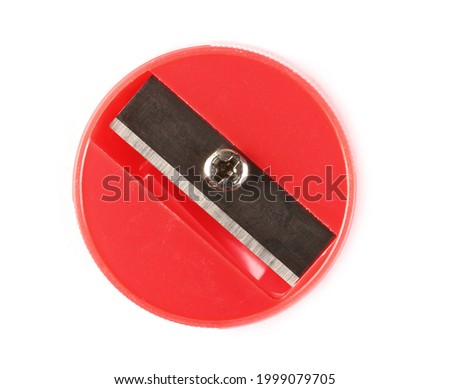 Round red plastic pencil sharpener isolated on white background, top view Royalty-Free Stock Photo #1999079705